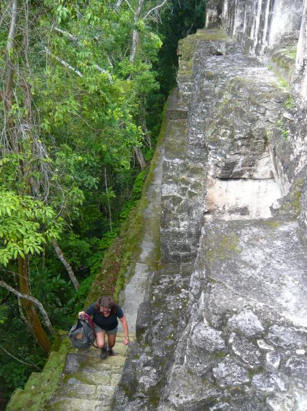 P1000838.JPG - Colleen walking up the narrow steps of one of the temples. The jungle always threatens to take over the site once again.