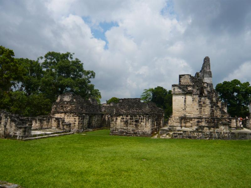 P1000836.JPG - To get to the main site is about a half hour walk through the jungle from the site entrance. Our guide spent a good deal of time telling us about the Mayan counting and calculating system - a base 20 system.