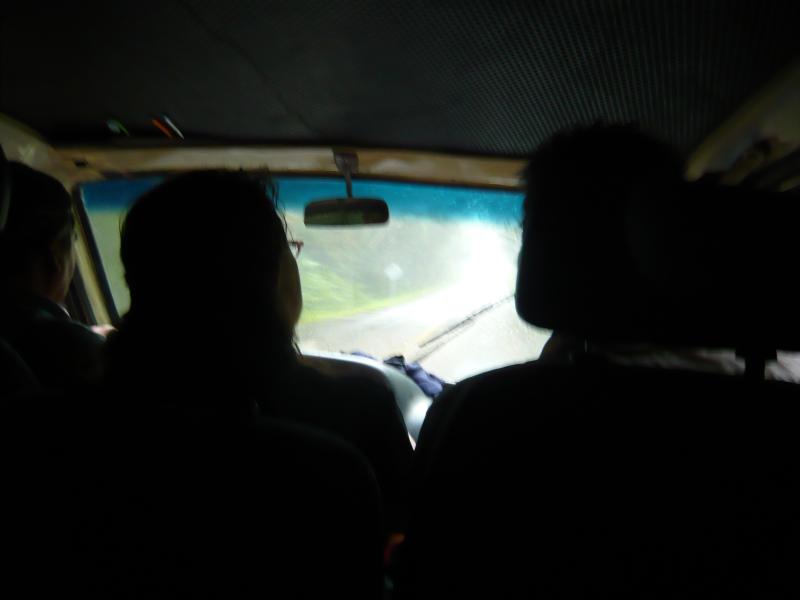 P1000871.JPG - The van that took us from the airport broke down so we are crammed into a "cooperativa" a little public bus that took us to the airport. Rain was coming down in sheets as we drove back toward Flores.